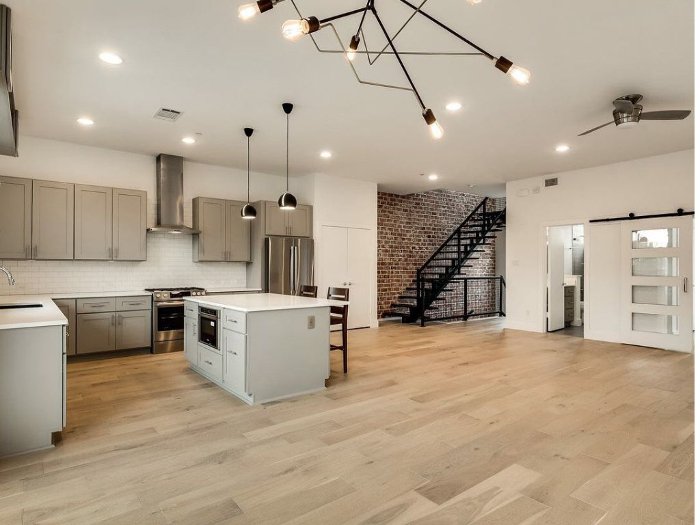 Wide plank wood flooring in an open concept kitchen