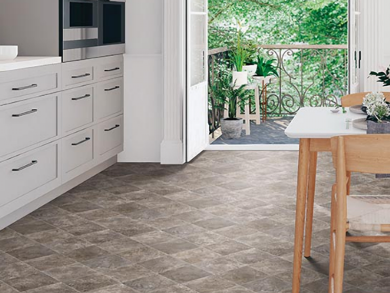 Warm grey Mohawk LVT floors add earthy balance to a sleek modern kitchen