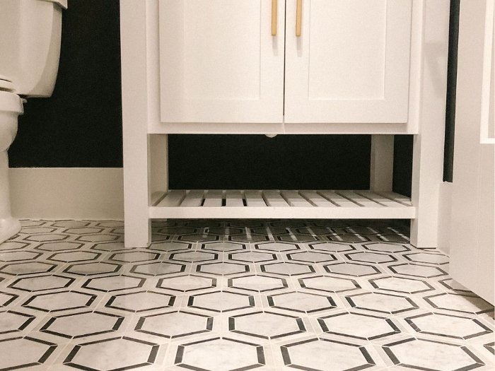 Black and white honeycomb tile on a bathroom floor